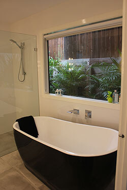apartment bathroom with bath below window