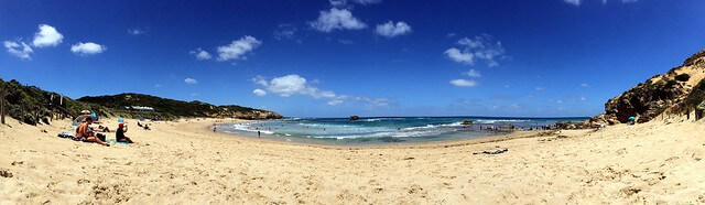 Panorama photo of beach with tourists